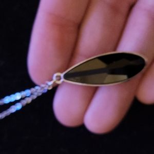 black teardrop and silver necklace